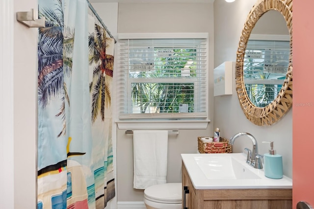 bathroom with a shower with curtain, toilet, and vanity