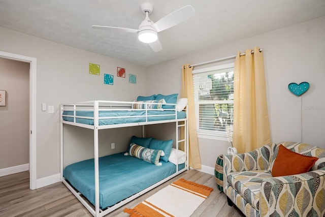 bedroom with baseboards, ceiling fan, and wood finished floors
