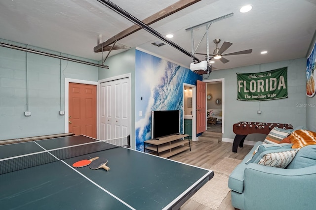 recreation room with a garage, wood finished floors, recessed lighting, and a ceiling fan