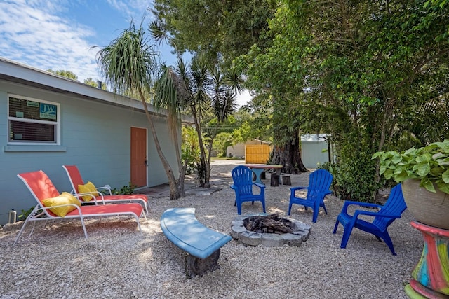 view of yard with a fire pit and a patio