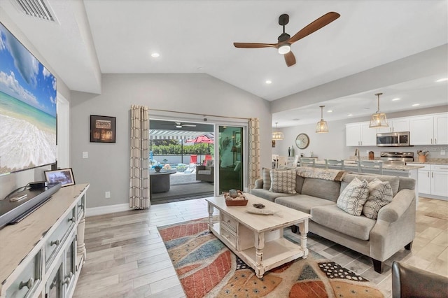 145 Baytree Dr, Rotonda West, FL 33947 - living area featuring a ceiling fan, light wood finished floors, vaulted ceiling, recessed lighting, and baseboards
