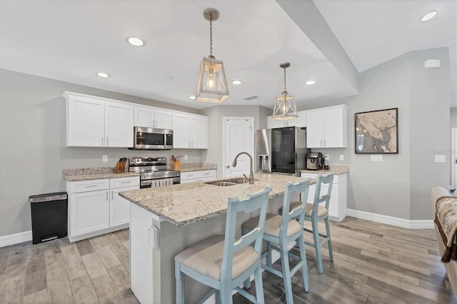 145 Baytree Dr, Rotonda West, FL 33947 - kitchen with appliances with stainless steel finishes, a sink, baseboards, recessed lighting, and light wood-style floors