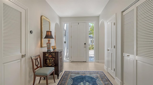 entryway featuring light tile patterned floors and baseboards