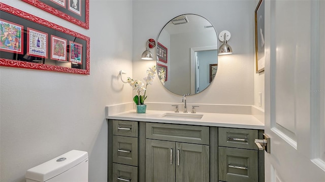 half bathroom with toilet and vanity