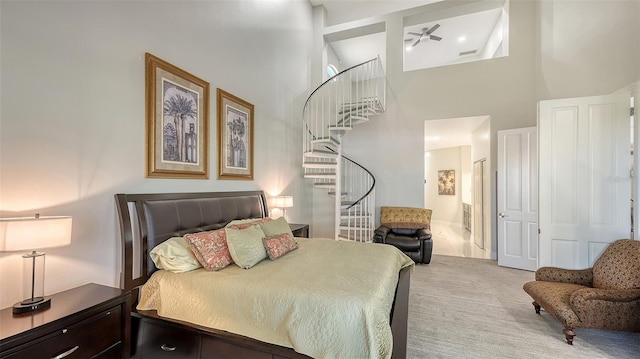 bedroom featuring connected bathroom, a towering ceiling, and carpet floors