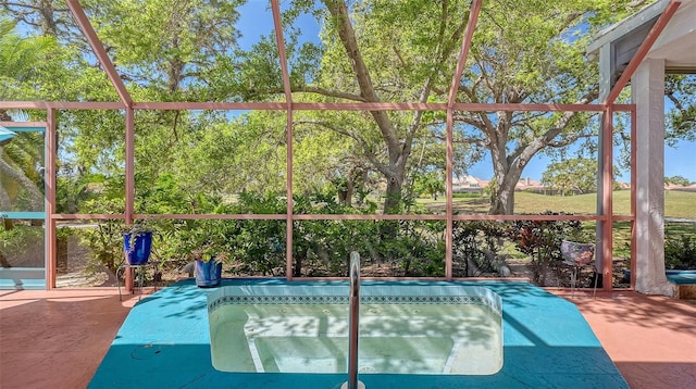 view of swimming pool featuring glass enclosure