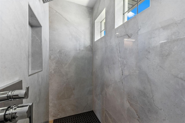 bathroom with tiled shower