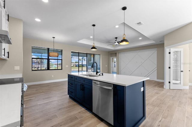 kitchen with a tray ceiling, electric stove, a sink, and dishwasher