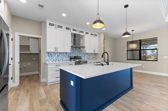 kitchen featuring a sink, wall chimney exhaust hood, tasteful backsplash, visible vents, and stainless steel electric stove