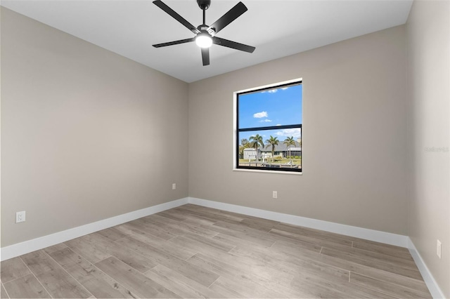 empty room with baseboards, light wood-style flooring, and a ceiling fan
