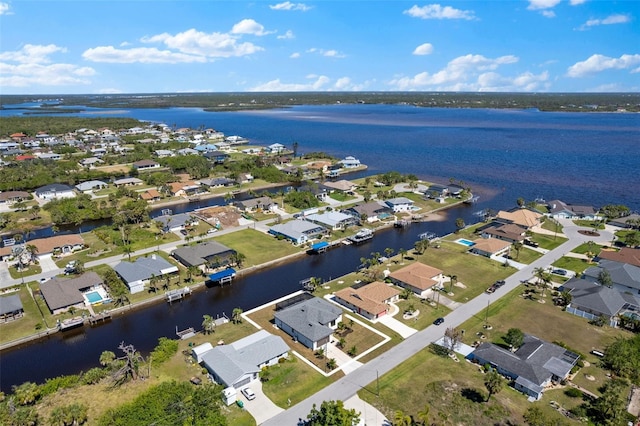 birds eye view of property with a residential view and a water view