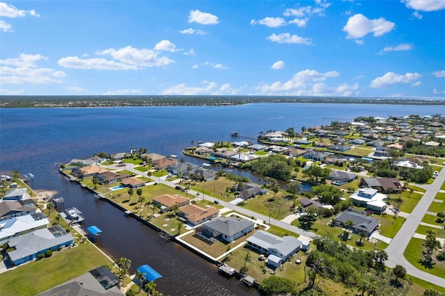 birds eye view of property featuring a residential view and a water view