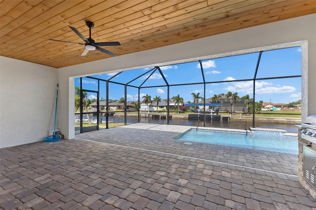 view of swimming pool with a water view, a lanai, ceiling fan, and a patio area