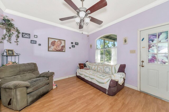 2070 59th St, Sarasota, FL 34243 - living area with light wood-type flooring, crown molding, ceiling fan, and arched walkways