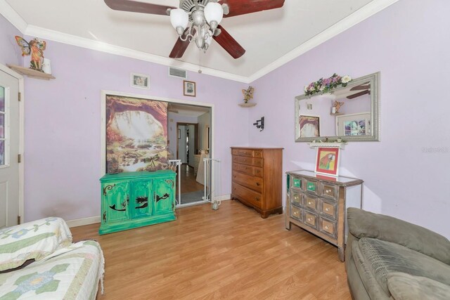 2070 59th St, Sarasota, FL 34243 - sitting room with wood finished floors, a ceiling fan, and crown molding