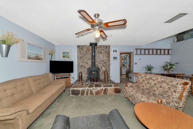 2070 59th St, Sarasota, FL 34243 - living area with a wood stove, carpet floors, and a ceiling fan