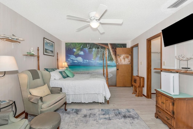 2070 59th St, Sarasota, FL 34243 - bedroom featuring ceiling fan, light wood-type flooring, and a textured ceiling