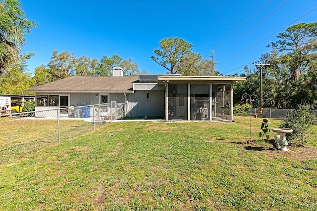 2070 59th St, Sarasota, FL 34243 - rear view of property with a sunroom, a fenced backyard, board and batten siding, and a chimney