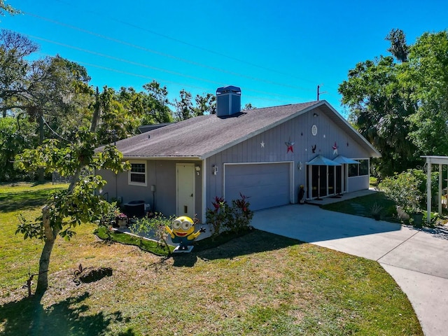 2070 59th St, Sarasota, FL 34243 - ranch-style house with a garage, a chimney, a front yard, and concrete driveway