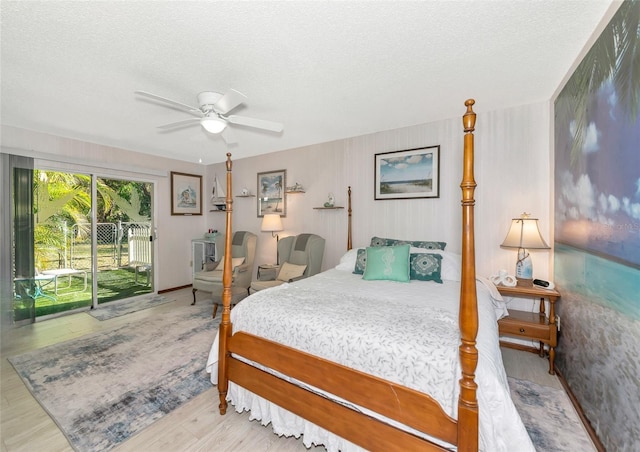 2070 59th St, Sarasota, FL 34243 - bedroom featuring access to outside, a textured ceiling, wood finished floors, and a ceiling fan