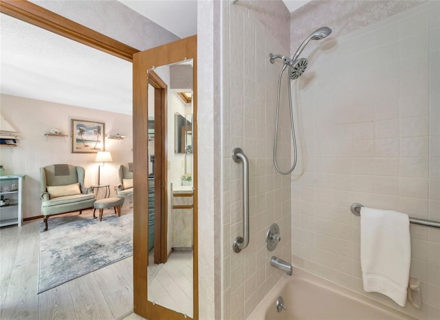 2070 59th St, Sarasota, FL 34243 - bathroom with wood finished floors and washtub / shower combination