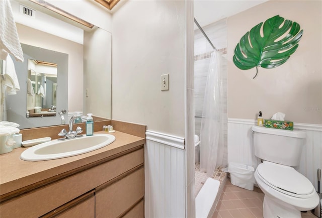 2070 59th St, Sarasota, FL 34243 - bathroom featuring a wainscoted wall, vanity, a shower stall, and tile patterned flooring