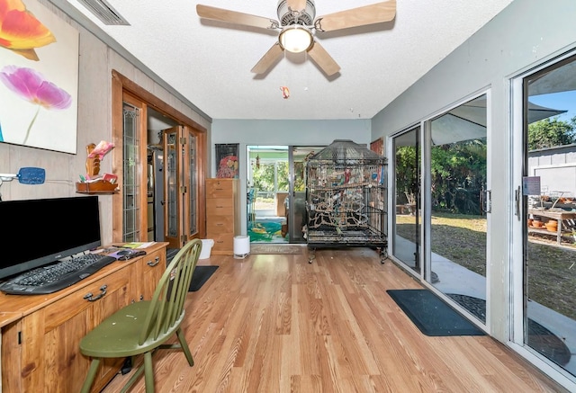 2070 59th St, Sarasota, FL 34243 - exercise room featuring wood finished floors, a ceiling fan, and a textured ceiling