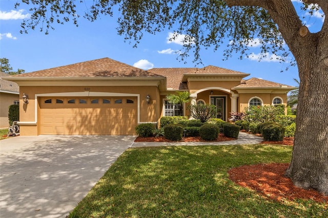 12211 Aster Ave, Bradenton, FL 34212 - view of front of house with stucco siding, an attached garage, concrete driveway, and a front yard