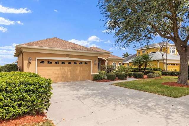 12211 Aster Ave, Bradenton, FL 34212 - view of front of home with an attached garage, a front yard, roof with shingles, stucco siding, and driveway