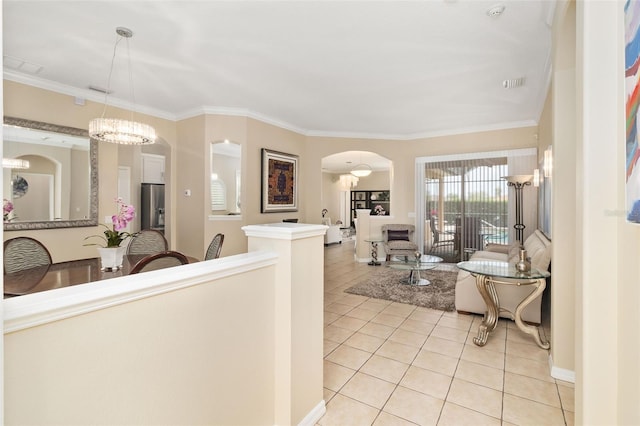 12211 Aster Ave, Bradenton, FL 34212 - interior space featuring visible vents, ornamental molding, arched walkways, light tile patterned floors, and a chandelier