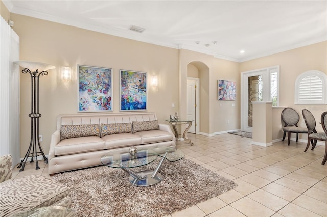 12211 Aster Ave, Bradenton, FL 34212 - living area featuring light tile patterned floors, visible vents, baseboards, arched walkways, and ornamental molding