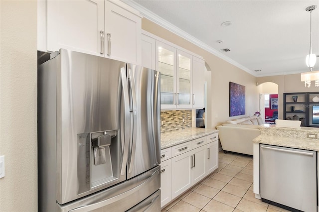 12211 Aster Ave, Bradenton, FL 34212 - kitchen featuring ornamental molding, tasteful backsplash, open floor plan, arched walkways, and appliances with stainless steel finishes