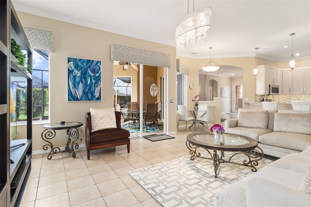 12211 Aster Ave, Bradenton, FL 34212 - living room featuring light tile patterned floors, arched walkways, a wealth of natural light, and crown molding