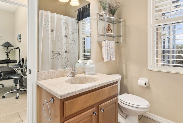 12211 Aster Ave, Bradenton, FL 34212 - bathroom with toilet, a healthy amount of sunlight, vanity, and tile patterned flooring