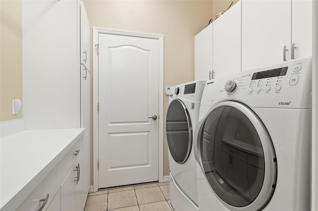 12211 Aster Ave, Bradenton, FL 34212 - washroom featuring light tile patterned flooring, cabinet space, and washer and clothes dryer