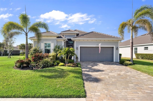 25325 Longmeadow Dr, Punta Gorda, FL 33955 - view of front of home featuring a garage, decorative driveway, a front lawn, and a tiled roof