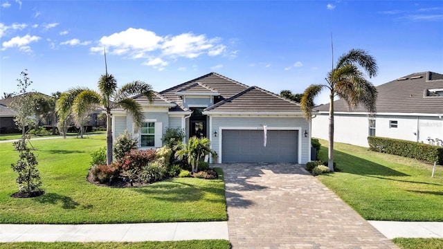 25325 Longmeadow Dr, Punta Gorda, FL 33955 - view of front of house featuring an attached garage, a tile roof, decorative driveway, and a front yard