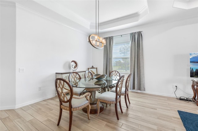 25325 Longmeadow Dr, Punta Gorda, FL 33955 - dining room featuring baseboards, light wood finished floors, a tray ceiling, ornamental molding, and a chandelier