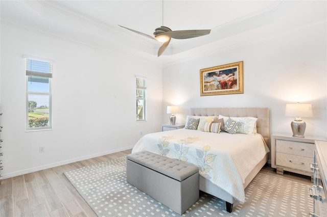 25325 Longmeadow Dr, Punta Gorda, FL 33955 - bedroom featuring a tray ceiling, wood finished floors, and ornamental molding
