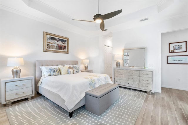 25325 Longmeadow Dr, Punta Gorda, FL 33955 - bedroom with wood finished floors, a closet, baseboards, a raised ceiling, and ceiling fan