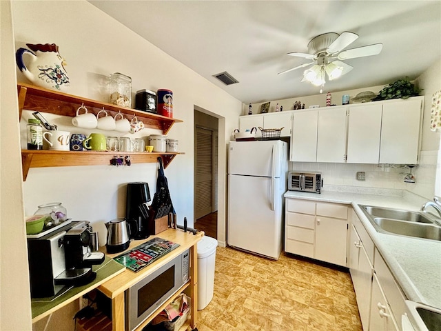 1633 Leisure Dr Unit M-37, Bradenton, FL 34207 - kitchen featuring ceiling fan, light countertops, freestanding refrigerator, white cabinets, and a sink