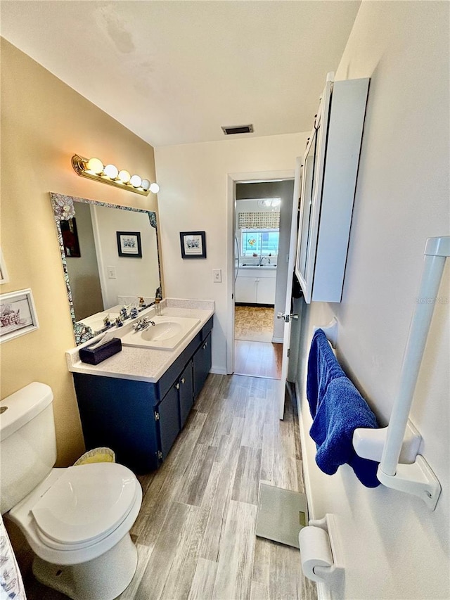1633 Leisure Dr Unit M-37, Bradenton, FL 34207 - bathroom with visible vents, toilet, wood finished floors, and vanity
