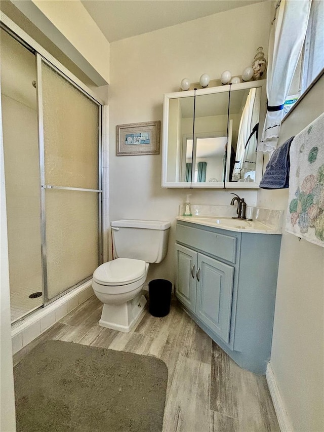 1633 Leisure Dr Unit M-37, Bradenton, FL 34207 - full bath with vanity, wood finished floors, baseboards, a stall shower, and toilet