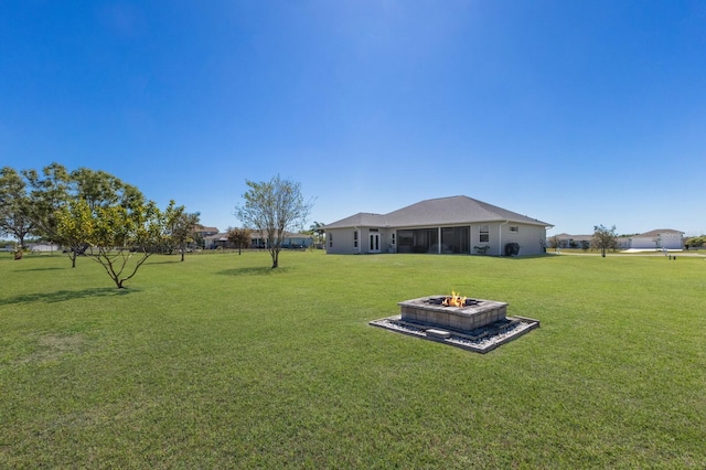 4606 Lake Fox Pl, Parrish, FL 34219 - view of grassy yard featuring a fire pit and a sunroom