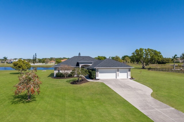 4606 Lake Fox Pl, Parrish, FL 34219 - view of front of home featuring a front lawn, a garage, driveway, and a water view