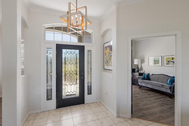 4606 Lake Fox Pl, Parrish, FL 34219 - tiled entryway with ornamental molding, a chandelier, baseboards, and arched walkways