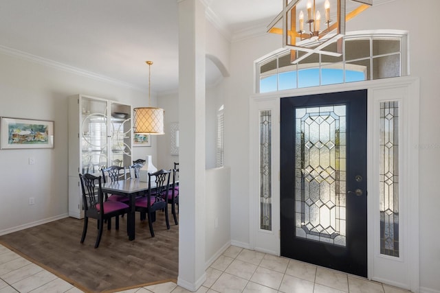 4606 Lake Fox Pl, Parrish, FL 34219 - entrance foyer featuring a chandelier, ornamental molding, wood finished floors, baseboards, and arched walkways