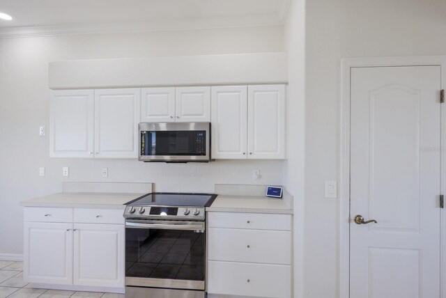 4606 Lake Fox Pl, Parrish, FL 34219 - kitchen with stainless steel appliances, ornamental molding, white cabinets, light countertops, and baseboards