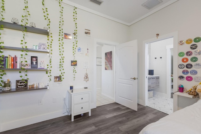 4606 Lake Fox Pl, Parrish, FL 34219 - bedroom with dark wood-style floors, baseboards, ensuite bath, and crown molding