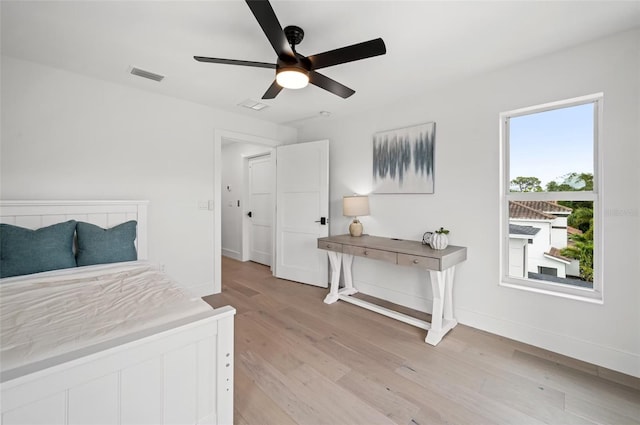 1647 Siesta Dr, Sarasota, FL 34239 - bedroom with light wood-type flooring, baseboards, and ceiling fan